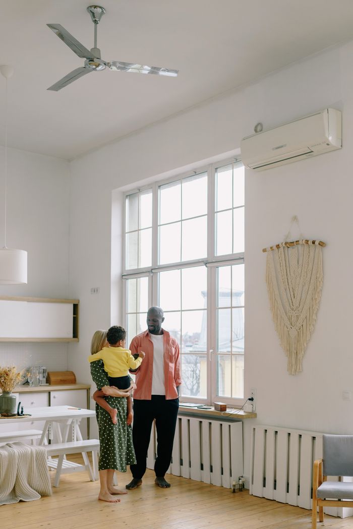 Services A diverse family spending quality time in a bright, modern living room. Airy and warm atmosphere.